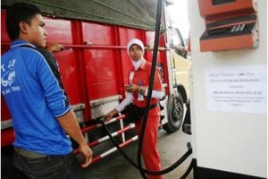 Seorang petugas SPBU saat melayani pembelian BBM bersubsidi.